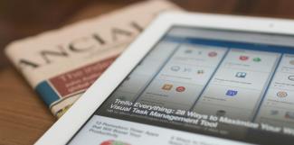 white tablet computer on top of newspaper by Matthew Guay courtesy of Unsplash.