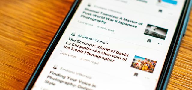 a cell phone sitting on top of a wooden table by Emiliano Vittoriosi courtesy of Unsplash.