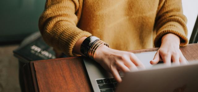 person using laptop computer by Christin Hume courtesy of Unsplash.