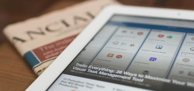 white tablet computer on top of newspaper by Matthew Guay courtesy of Unsplash.