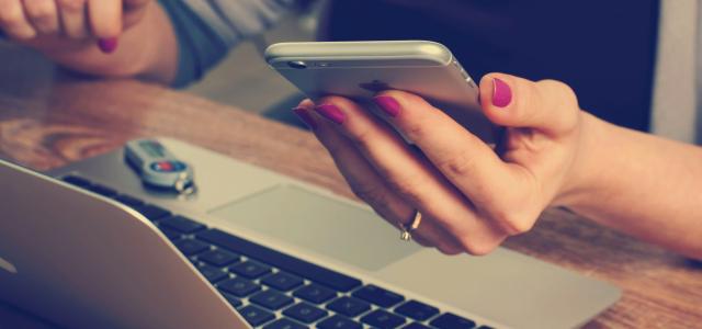 woman holding silver iPhone 6 by Firmbee.com courtesy of Unsplash.